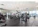 Large gym with a variety of equipment, mirrors, bright lighting, and city views at 1901 Wazee St # 807, Denver, CO 80202