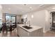 Open concept kitchen island flowing into dining, and featuring modern fixtures and a city view at 1901 Wazee St # 807, Denver, CO 80202