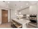 Modern kitchen with stainless steel appliances, sleek white cabinetry, and a large center island at 1901 Wazee St # 807, Denver, CO 80202