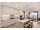 Modern kitchen with stainless steel appliances, a large island with seating, and sleek white cabinetry at 1901 Wazee St # 807, Denver, CO 80202