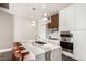 Sleek kitchen island with a waterfall countertop, modern sink fixtures, and updated stainless steel appliances at 1901 Wazee St # 807, Denver, CO 80202