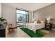 Bright bedroom featuring a large window showcasing the city skyline and comfortable furnishings at 1901 Wazee St # 807, Denver, CO 80202