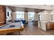 Large recreation room boasting a pool table, fireplace, and kitchen island with an open floor plan at 1901 Wazee St # 807, Denver, CO 80202