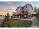 Large deck with hot tub and stairs leading down to the yard at 10918 Bellbrook Cir, Highlands Ranch, CO 80130