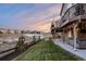 Landscaped backyard with a deck and hot tub, offering a view of the neighborhood at 10918 Bellbrook Cir, Highlands Ranch, CO 80130