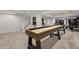 Finished basement with a shuffleboard table and gym at 10918 Bellbrook Cir, Highlands Ranch, CO 80130