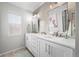 Modern bathroom with double vanity and hexagon tile at 10918 Bellbrook Cir, Highlands Ranch, CO 80130