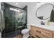 Modern bathroom with a walk-in shower and wood vanity at 10918 Bellbrook Cir, Highlands Ranch, CO 80130