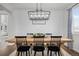 Farmhouse style dining room with wooden table and black chairs at 10918 Bellbrook Cir, Highlands Ranch, CO 80130