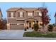 Two-story house with a large front yard, attached garage, and landscaping at 10918 Bellbrook Cir, Highlands Ranch, CO 80130