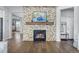 Bright living room with a stone fireplace and built-in shelving at 10918 Bellbrook Cir, Highlands Ranch, CO 80130