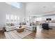 Open concept living room and kitchen with hardwood floors at 10918 Bellbrook Cir, Highlands Ranch, CO 80130