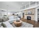 Open concept living room with a stone fireplace and high ceilings at 10918 Bellbrook Cir, Highlands Ranch, CO 80130