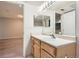 Bathroom with a wood vanity and a view to the hall at 5201 S Fox St # 102, Littleton, CO 80120
