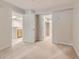 Bright bedroom with neutral walls, carpet flooring, and access to a closet and bathroom at 5201 S Fox St # 102, Littleton, CO 80120