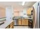 Modern kitchen with stainless steel appliances, wooden cabinets, and efficient layout at 5201 S Fox St # 102, Littleton, CO 80120