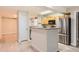 Kitchen showcasing stainless steel appliances, wooden cabinets, and a breakfast bar at 5201 S Fox St # 102, Littleton, CO 80120