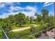 Scenic view of lush green landscape with walking path, mature trees, and sunny blue skies, perfect for outdoor enjoyment at 5201 S Fox St # 102, Littleton, CO 80120