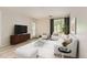 Staged living room with light wood floors, white furniture, and modern decor at 5201 S Fox St # 102, Littleton, CO 80120