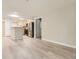 Spacious open floor plan with light wood floors connecting living area and kitchen at 5201 S Fox St # 102, Littleton, CO 80120