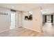 An open living room features a view of the kitchen area and a door to the balcony at 5201 S Fox St # 102, Littleton, CO 80120