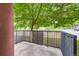 Outdoor patio area with a privacy screen and view of trees and the neighborhood at 5201 S Fox St # 102, Littleton, CO 80120