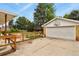 Backyard with a well-maintained garage and a charming garden enclosed by a wooden fence at 4040 Cody St, Wheat Ridge, CO 80033