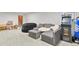 Spacious basement featuring gray sectional sofa, game area and plenty of room to entertain at 4040 Cody St, Wheat Ridge, CO 80033