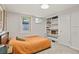 Comfortable bedroom with built-in shelves and a large window for natural light at 4040 Cody St, Wheat Ridge, CO 80033