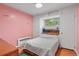 Cozy bedroom with pink walls, built-in storage, and a comfortable bed at 4040 Cody St, Wheat Ridge, CO 80033