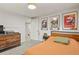 Cozy bedroom features neutral walls, wood furniture, and travel themed wall art at 4040 Cody St, Wheat Ridge, CO 80033
