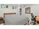 Bedroom featuring gray carpet, a bed with a black and white cover, and built-in shelves at 4040 Cody St, Wheat Ridge, CO 80033