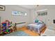 Bright bedroom with hardwood floors, playful decor, and ample storage space at 4040 Cody St, Wheat Ridge, CO 80033