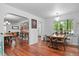 Open-concept dining area with hardwood floors, a cozy table, and ample natural light at 4040 Cody St, Wheat Ridge, CO 80033