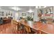 Spacious dining area featuring hardwood floors, a grand wooden table, and unique decor at 4040 Cody St, Wheat Ridge, CO 80033
