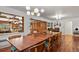 Bright dining area with a large wooden table, stylish lighting, and hardwood floors for elegant entertaining at 4040 Cody St, Wheat Ridge, CO 80033