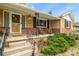 Inviting front porch with brick accents and space to relax outside at 4040 Cody St, Wheat Ridge, CO 80033