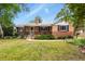 Charming brick home with a well-manicured lawn and mature trees in a desirable neighborhood at 4040 Cody St, Wheat Ridge, CO 80033