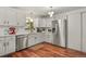 Modern kitchen with white cabinets, stainless steel appliances and hardwood floors at 4040 Cody St, Wheat Ridge, CO 80033