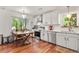 Bright kitchen with white cabinets, stainless steel appliances, and a cozy dining area for casual meals at 4040 Cody St, Wheat Ridge, CO 80033
