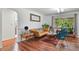 Living room with hardwood floors, decorative rug and leather sofa at 4040 Cody St, Wheat Ridge, CO 80033