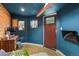 Office with teal walls, wood floors, and a decorative front door for added privacy at 4040 Cody St, Wheat Ridge, CO 80033