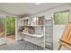 Bright studio space with shelving, natural light, and an open doorway to the outside at 4040 Cody St, Wheat Ridge, CO 80033
