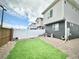 A well-kept backyard with artificial turf, a white privacy fence, and a gravel border at 5027 N Walden Way, Denver, CO 80249