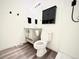 Well-lit bathroom featuring a gray vanity, black fixtures, and sleek, modern design at 5027 N Walden Way, Denver, CO 80249