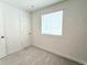 Bright and airy bedroom with neutral carpeting and a large window for natural light at 5027 N Walden Way, Denver, CO 80249
