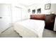 Bright bedroom featuring a cozy bed with white bedding, complemented by stylish decor and ample closet space at 5027 N Walden Way, Denver, CO 80249