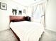 Cozy bedroom with soft carpet, a comfortable bed, neutral decor, and natural light from the window at 5027 N Walden Way, Denver, CO 80249