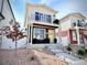 Charming two-story home with a balcony, landscaped front yard, and inviting entryway on a sunny day at 5027 N Walden Way, Denver, CO 80249