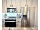Modern kitchen features stainless steel appliances and ample counter space, perfect for cooking and entertaining at 5027 N Walden Way, Denver, CO 80249